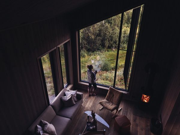 an overhead shot of a woman sipping coffee from her forest retreat with Up Norway