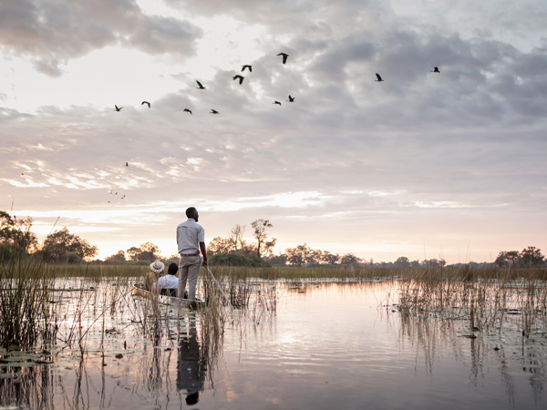 riding a mokoro at Vumbura Plains