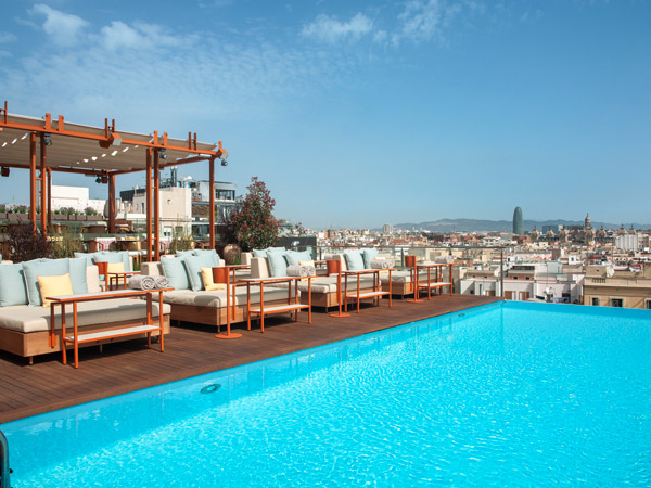 the rooftop pool with cabanas at Grand Hotel Central Barcelona
