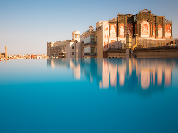 the pool and building exterior of Grand Hotel Central Barcelona