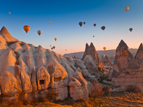 hot air balloons over Goreme Valley in Cappadocia, Turkey
