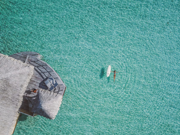 Aerial shot of woman in water in Taha’a, Tahiti