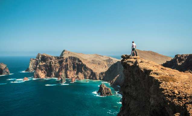 Man standing on cliff in Madeira
