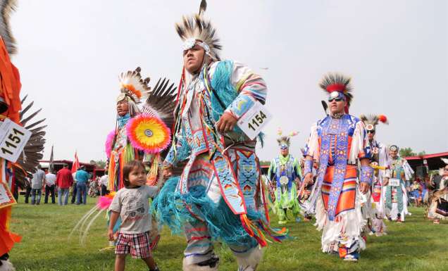 tribal dancers in colourful costumes at United Tribes Technical College (UTTC) International Powwow