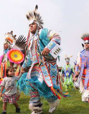 tribal dancers in colourful costumes at United Tribes Technical College (UTTC) International Powwow