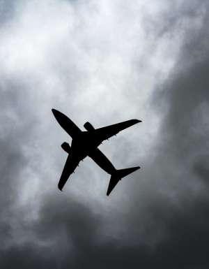 passenger plane under white clouds