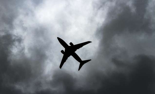 passenger plane under white clouds