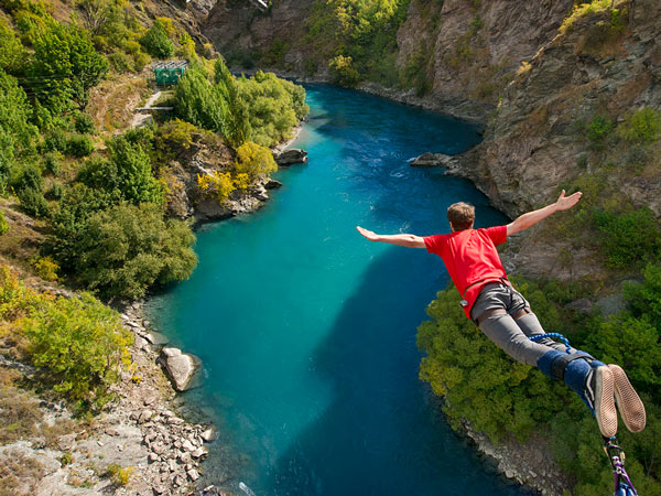 Man doing bungee jump from Kawarau Bridge Bungy in Queenstown, New Zealand