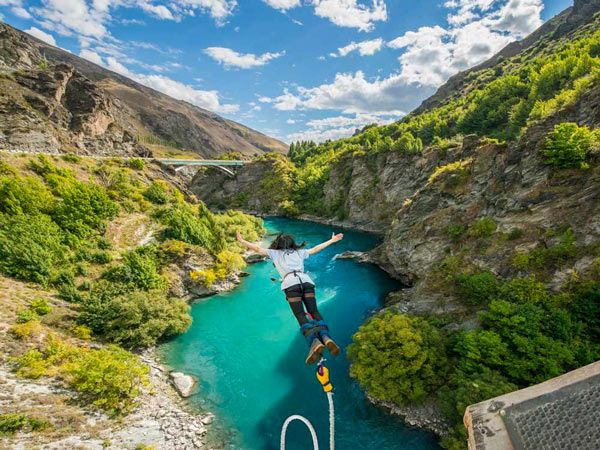 Woman doing bungee jump from Kawarau Bridge Bungy in Queenstown, New Zealand