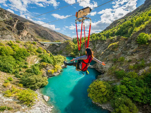 Woman doing zip ride from Kawarau Bridge Bungy in Queenstown, New Zealand