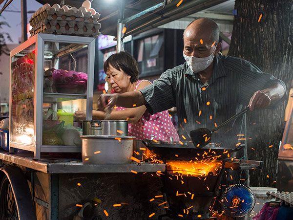 a street food vendor in penang cooks up a tasty dish