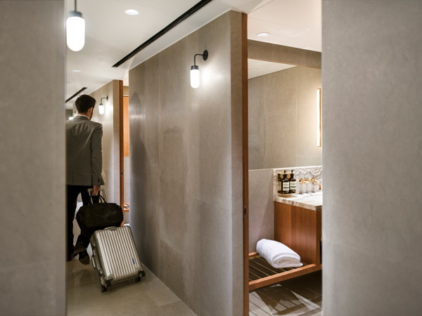 a man with a suitcase at The Pier, Cathay Pacific Business lounge