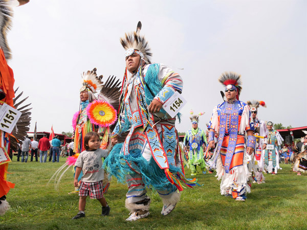 tribal dancers in colourful costumes at United Tribes Technical College (UTTC) International Powwow