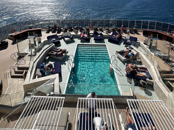 guests relaxing on day beds at Atoll Pool & Bar, Explora I