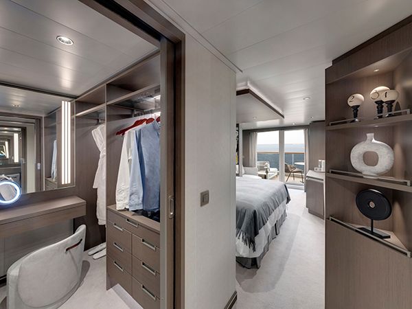 The Ocean Suite's walk-in robe, bedroom, and a view of the balcony.