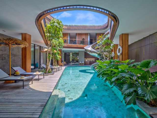 a pool with a spiral slide at Akashi Residence
