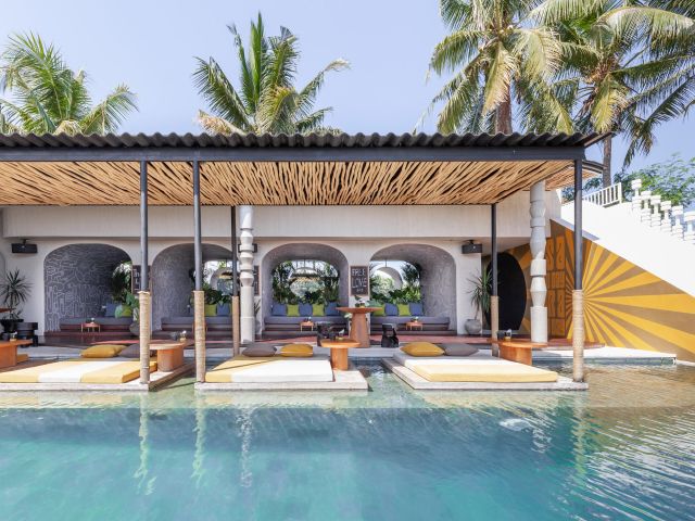an outdoor lounge and infinity pool at Soulshine Bali