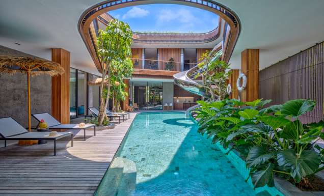 a pool with a spiral slide at Akashi Residence, Bali