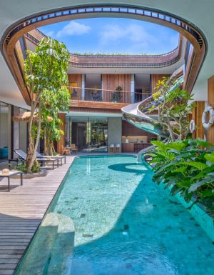 a pool with a spiral slide at Akashi Residence, Bali