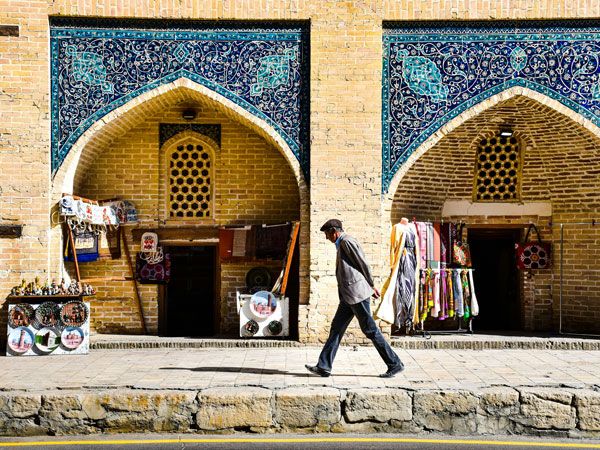 a man walking down the sidewalk in Bukhara, Uzbekistan