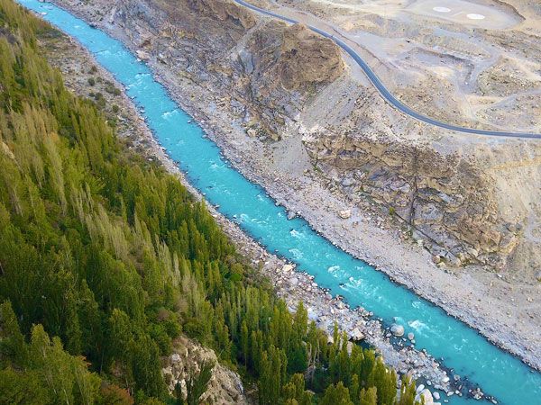 a blue river flowing through Karakoram mountain