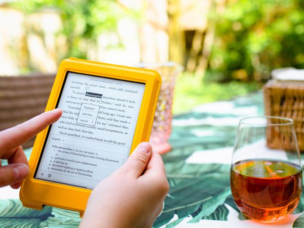 the Kobo Libra 2 with a yellow cover been read outside.