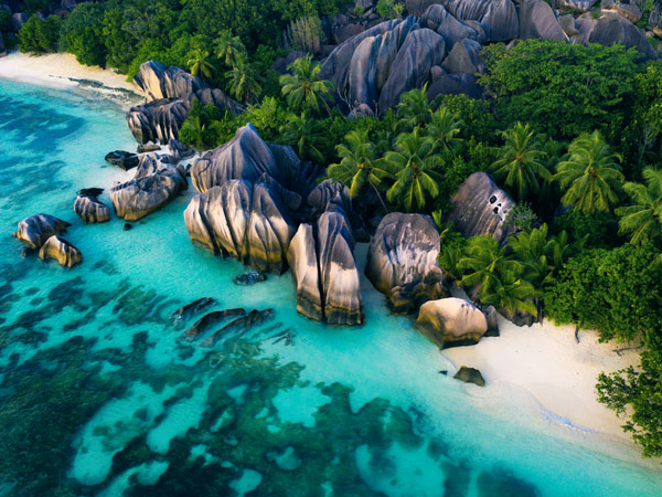 a white-sand beach with giant boulders at La Digue, Seychelles