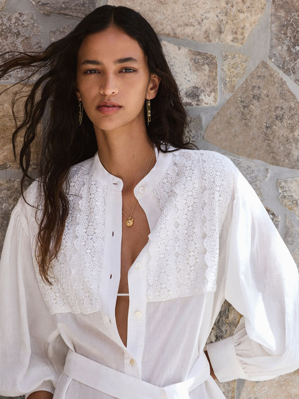 Woman modelling the white HANNAH artwear piece