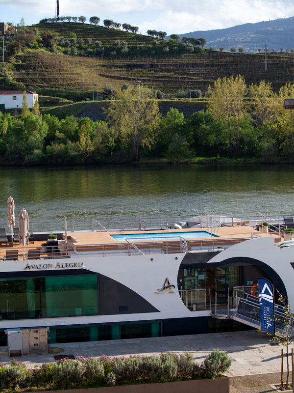 the Avalon Alegria docked by the side of the river