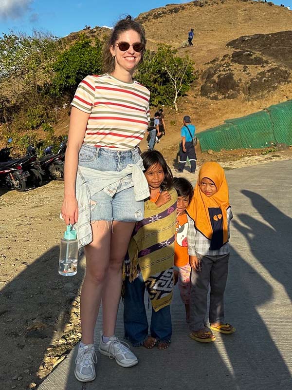 kassia byrnes tall woman posing with short kids in indonesia