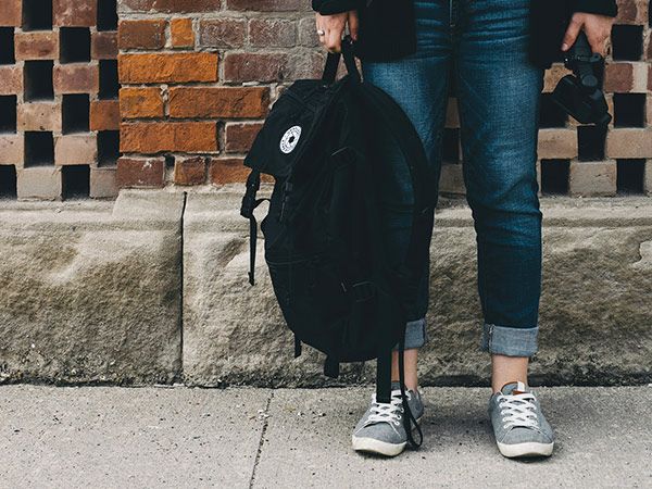 person holding backpack