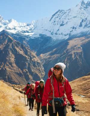 a group of travellers traversing Annapurna Base Camp with Intrepid Travel