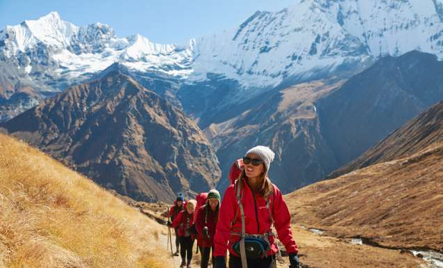 a group of travellers traversing Annapurna Base Camp with Intrepid Travel