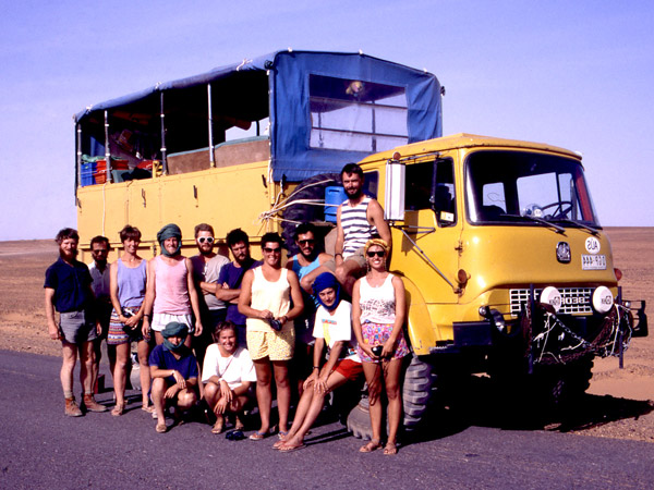 a group photo of Intrepid travellers on the side of a truck in Africa