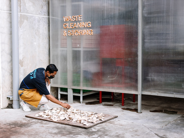 a staff working on a design project at the Waste Lab of Desa Potato Head, Bali
