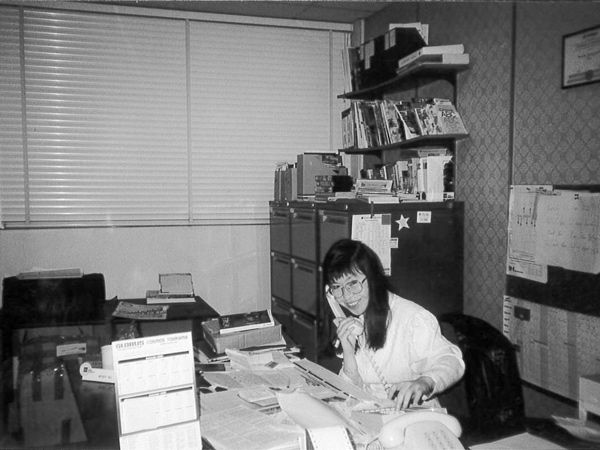 Wendy Wu talking on the phone in her office