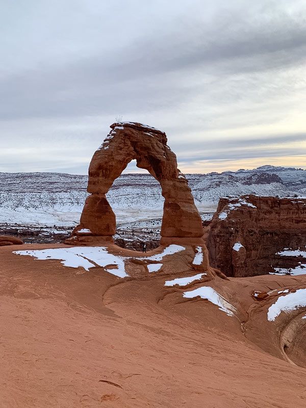 The writer under Delicate Arch in Arches National Park, Utah. 