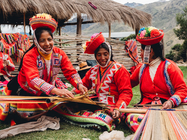 the Indigenous women of Huilloc weaving in Peru