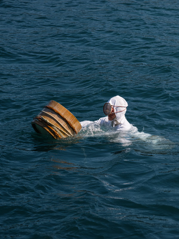 an ama diver in Japan holding a bamboo basket