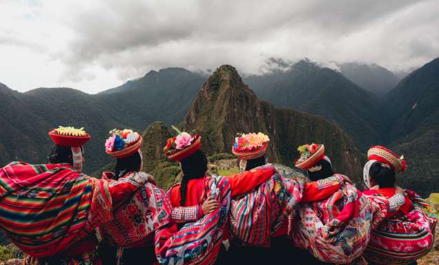 Quechua women from the Sacred Valley with arms linked