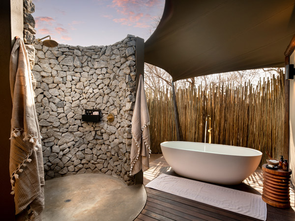 an alfresco bath and outdoor shower at andBeyond’s Ngala Tented Camp