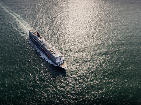 Queen Anne makes a grand entrance into Southampton in this stunning aerial shot, a highlight of ocean cruises 2025.