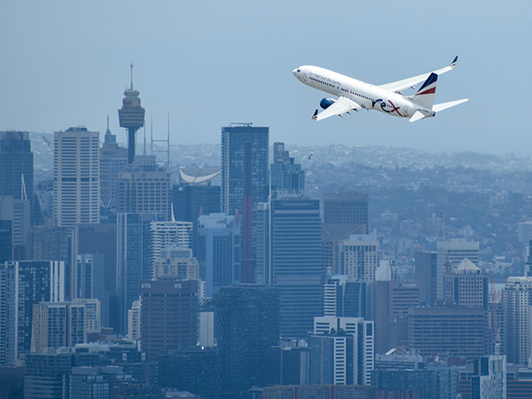 rex airlines plane flying over sydney