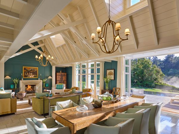 an elegant living room interior with pendant lights and a fireplace at Huka Lodge
