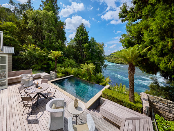 an outdoor terrace with a plunge pool at Huka Lodge