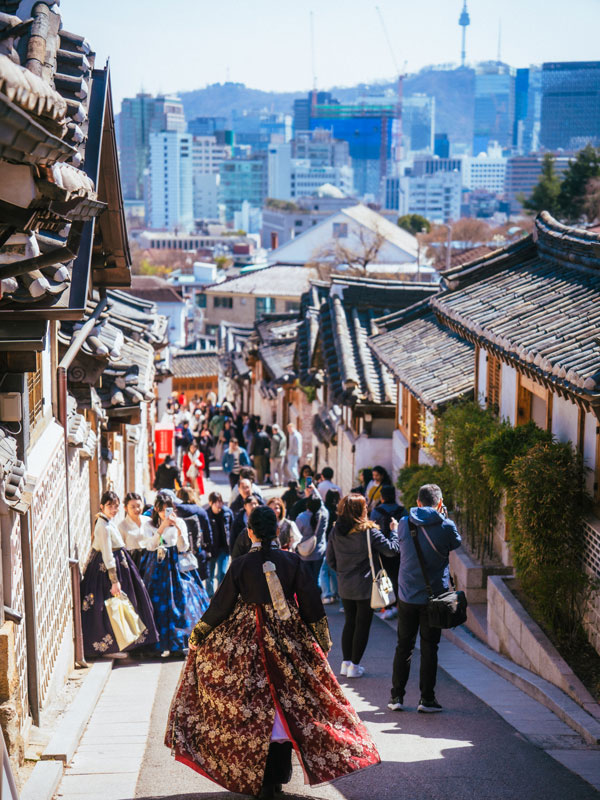 locals and visitors dressed in a hanbok in Bukchon Hanok Village