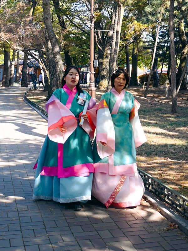 visitors dressed up in traditional hanbok at Daereungwon Tomb Complex, South Korea