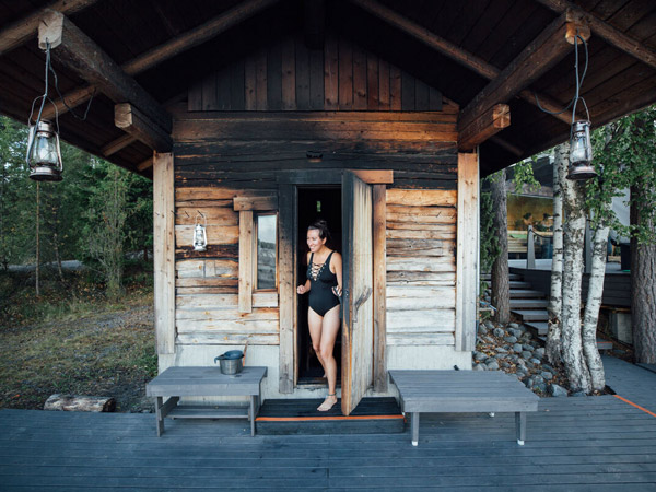 A woman exiting the sauna in Lehmonkarki Resort in Lahti 