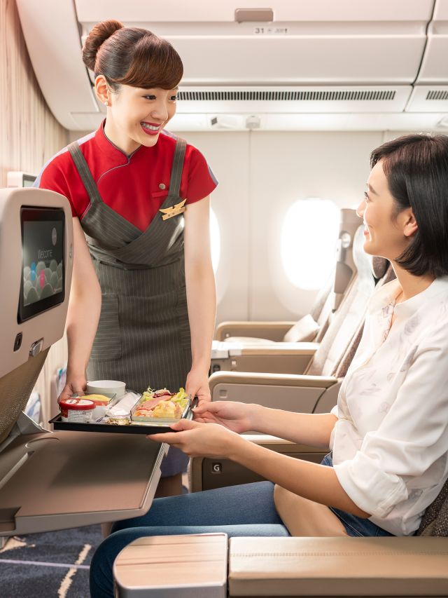 air stweard serving meal on china airlines flight