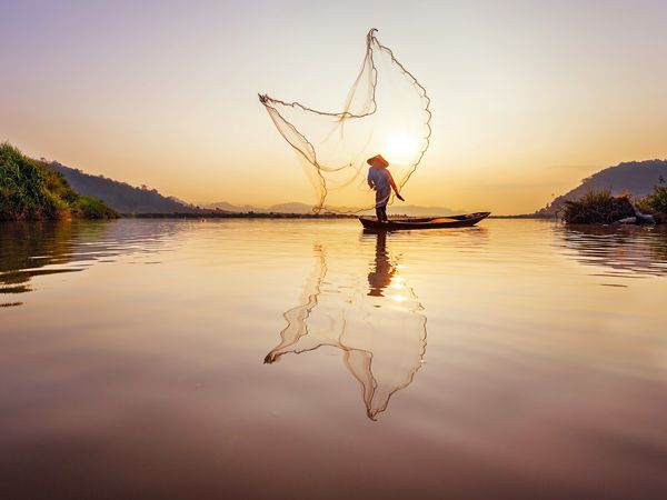 a fisherman casting net at Mekong River